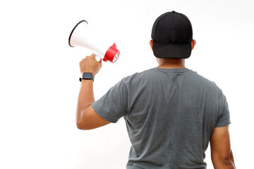 Back view of asian man standing while holding a megaphone. Protest concept