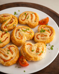 Puff pastry filled with salmon and cheese. Top view table with  decoration.