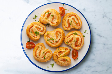 Puff pastry filled with salmon and cheese. Top view table with  decoration.