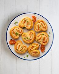 Puff pastry filled with salmon and cheese. Top view table with  decoration.