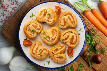 Puff pastry filled with salmon and cheese. Top view table with  decoration.