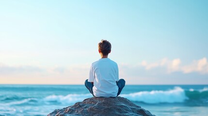 A person sitting on a rock overlooking the ocean, watching the waves roll in, feeling a sense of peace and tranquility.