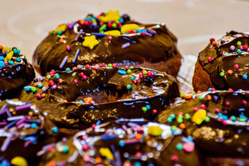 background of donuts with chocolate glaze and sprinkles