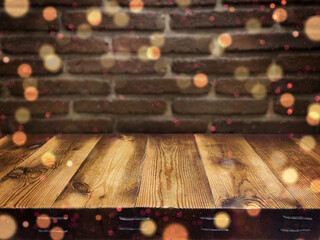 Festive, Christmas background. An empty wooden countertop against a dark brick wall. The backdrop. Bokeh. Defocus lights. Home interior. Copy space