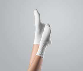 Template of white high socks on women's foot, with stretched toes, legs up presentation, side view, isolated on background.