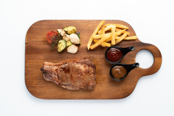 Delicious Feast of Steak, Fries, and Vegetables on Board