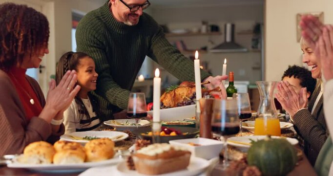 Man, serving and turkey with celebration for thanksgiving with happy family, feast and food for festive dinner or holiday. Interracial, people and together in house with meal, gratitude and applause.