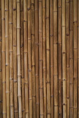 Bamboo trunks are dried and then arranged together to form a backdrop for the background.