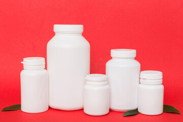 supplement pills with medicine bottle health care and medical top view. Vitamin tablets. Top view mockup bottle for pills and vitamins with green leaves, natural organic bio supplement, copy space