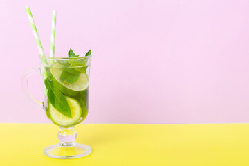 Mojito summer refreshing cocktail with ice and mint. mojito cocktail with lime, lemon and mint in a tall glass with a stick