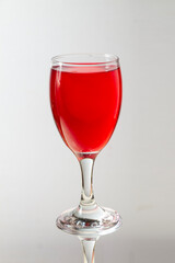 portrait of a glass of red syrup tulip beer on a terrazzo tile granite table