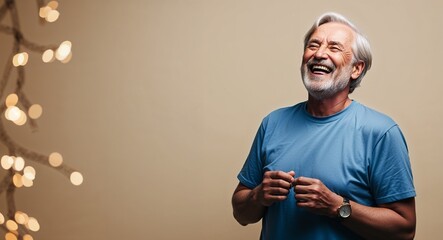 Laughing elderly Caucasian man with beard wearing tshirt on plain beige background