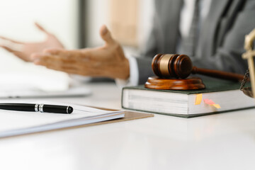 Justice in Session: Gavel, legal book, and papers on a desk, signifying legal proceedings or...