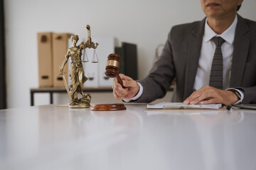 Justice is Served: Lawyer's gavel and Lady Justice statue on desk 
