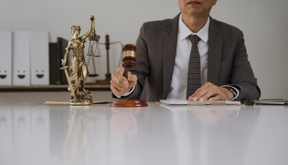 Justice in Session: A lawyer's hand reaches for the gavel, symbolizing legal proceedings and the...