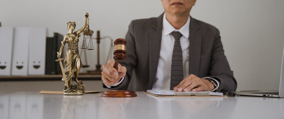 Judge's Gavel:  A lawyer's hand confidently holds a gavel, signifying justice and legal...