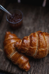croissant with jam on a wooden table
