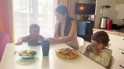 children eat breakfast. happy family kid dream concept. children in a family sit at the table and...