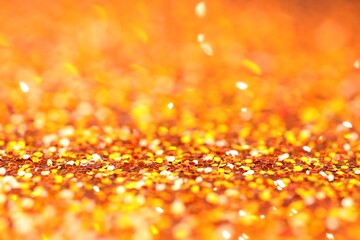 Beautiful shiny golden glitter as background, closeup