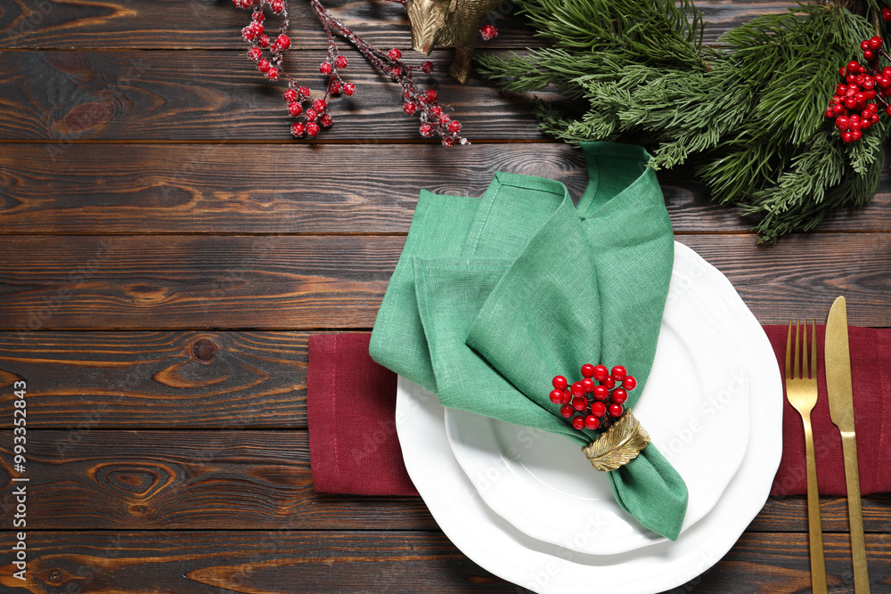 Sticker Christmas place setting with festive decor on wooden table, flat lay. Space for text