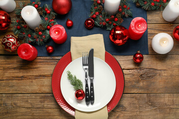 Christmas place setting with festive decor on wooden table, flat lay