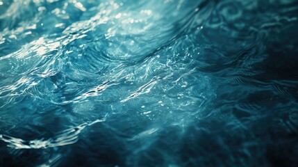 Close-up of transparent blue water with soft ripples and shining patterns, creating a peaceful and serene atmosphere. A perfect background texture.