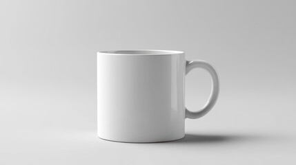 Fototapeta premium White ceramic mug with a handle on a plain white background.