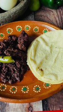 Dish full of moronga or blood sausage, with tortillas, a typical food from Mexico, Central America and Latin America made with rice, spices and pig's blood.