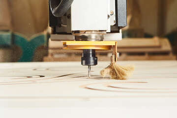 Cnc machine at carpentry workshop. Cutting wood with various router bits.