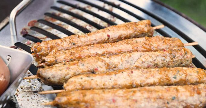 Traditional Turkish Adana Kebab. Turkish kebab barbecue grill with smoke.