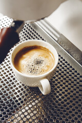 Close-up of a Brewed Americano Spilling on the Coffee Maker Stand During Preparation Beneath the Portafilter