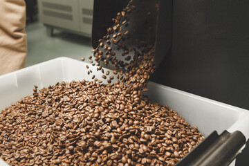 Obraz premium Coffee Beans Pouring Into White Container During Production