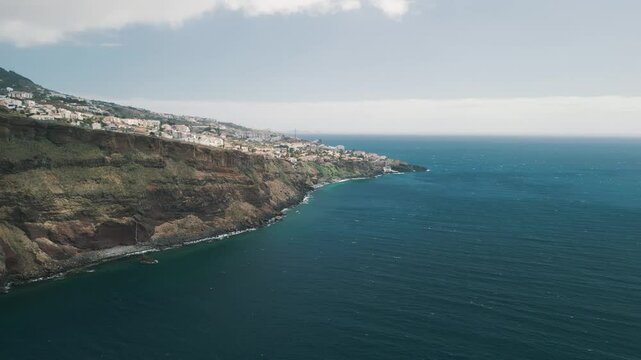 Rocky coastline of the Portuguese island of Madeira near Christo Rei, Canico. Drone aerial video.