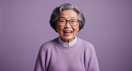Excited elderly Asian woman with glasses wearing sweater on plain lavender background