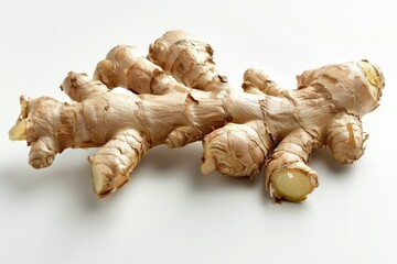 A close-up shot of a ginger root on a white surface