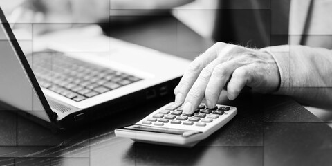 Hand of businessman using calculator, geometric pattern