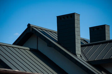 roof with black tile. modern roof tiles of metal. modern building in the city