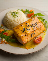 Baked salmon with orange sauce. Top view table with decoration.