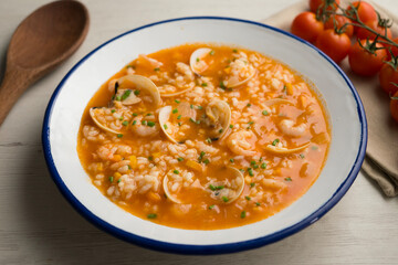 Rice soup with shrimp and clams. Top view table with  decoration.