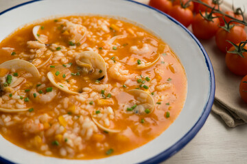Rice soup with shrimp and clams. Top view table with  decoration.