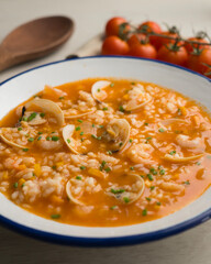 Rice soup with shrimp and clams. Top view table with  decoration.