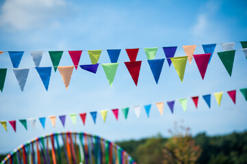 colorful flags hanging in the park. colorful bunting for celebration