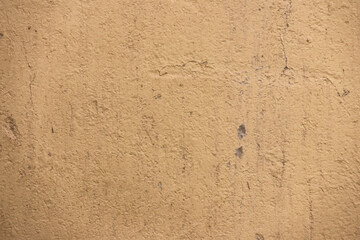 Golden decorative plaster covers uneven walls during apartment renovation. Repair and decoration of premises. Background texture pattern