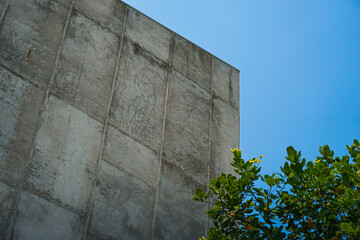 The architectural detail of a roofline on a home. Rusty roof  of old building against blue sky. view from below of old building with sky background