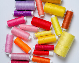 Top view of many colorful thread spools background