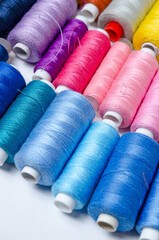Top view of many colorful thread spools background