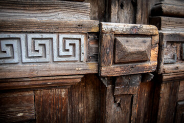Antique oak entrance door with decorations and carving. Dark wood texture
