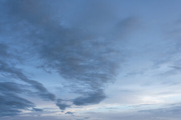 Dramatic timelapse of fluffy white clouds gathering in a blue sky, casting dark shadows as a summer...