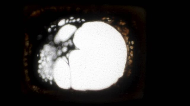 Melting yellow-brown cinematic film close-up. 4K Super 8