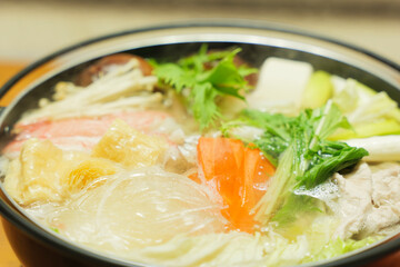 Traditional Japanese one-pot dish, consisting of carrots and other vegetables, mushrooms, meat, fish or crab, etc., simmered in a pot.